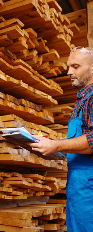 carpenter-in-uniform-check-boards-on-sawmill-2021-08-27-09-55-50-utc